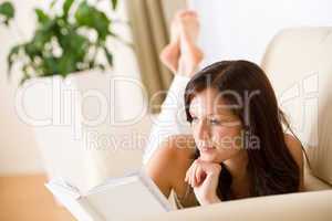 Young woman read book on sofa