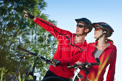 Young couple with mountine bike in spring nature