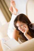 Young woman read book relaxing on sofa