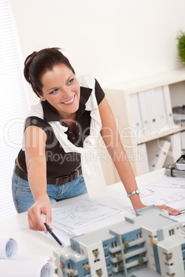 Young female architect with architectural model