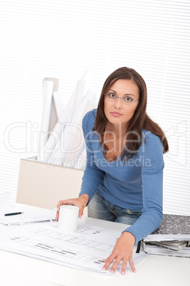 Attractive female architect working at the office