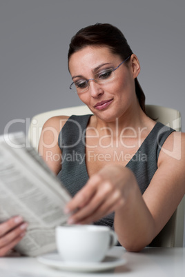 Successful businesswoman read newspaper at office