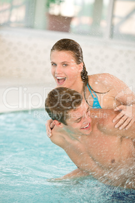 Swimming pool - young cheerful couple have fun