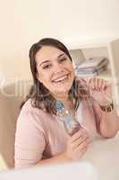 Young executive woman with bottle of water at office