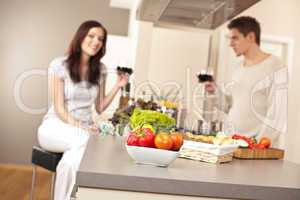 Young couple drinking red wine in kitchen