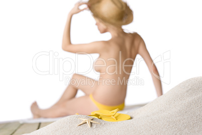 Beach - starfish with flip-flop on sand, woman in background