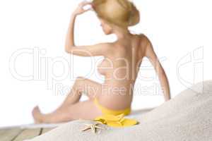 Beach - starfish with flip-flop on sand, woman in background