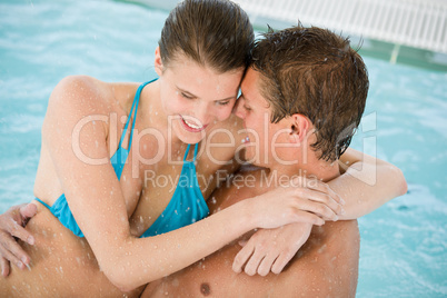 Young loving couple have fun in swimming pool