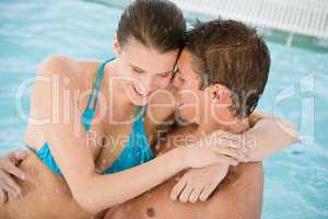 Young loving couple have fun in swimming pool
