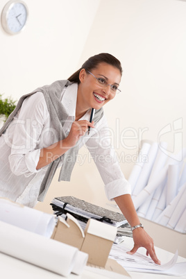 Female architect working at the office holding pen