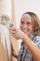 Home improvement: Young woman painting wall