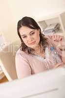 Young executive woman with bottle of water at office