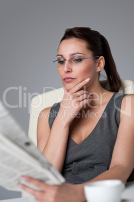 Successful businesswoman read newspaper at office