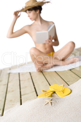 Beach - starfish with flip-flop on sand, woman in background