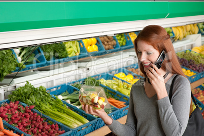 Grocery store shopping - Red hair woman with mobile phone