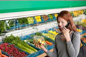 Grocery store shopping - Red hair woman with mobile phone