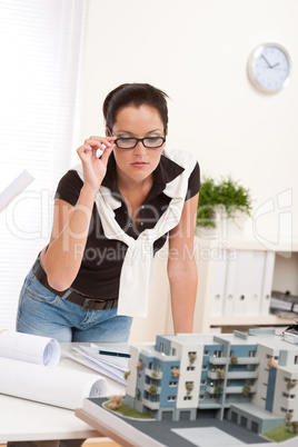 Young architect with glasses working at modern office