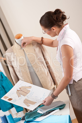 Female tailor working with fashion mannequin