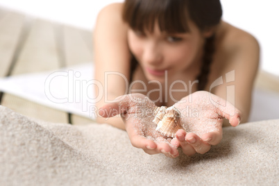 Beach - woman holding shell on sand