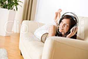 Woman with headphones listen to music in lounge