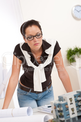 Young architect with glasses working at modern office