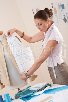 Female fashion designer working with pattern cutting