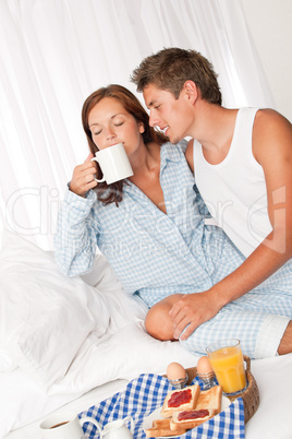 Young man and woman having breakfast together