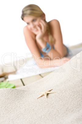 Beach - Starfish on sand, woman in background