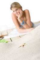 Beach - Starfish on sand, woman in background