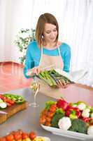 Cooking - Woman reading cookbook in kitchen