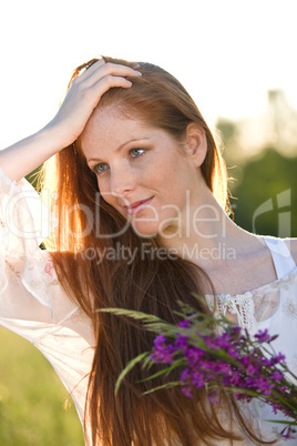 Long red hair woman with bouquet of flower