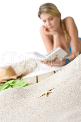 Beach - Starfish on sand, woman in background