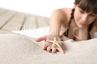 Beach - woman holding starfish on sand