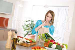 Cooking - Woman reading cookbook in kitchen