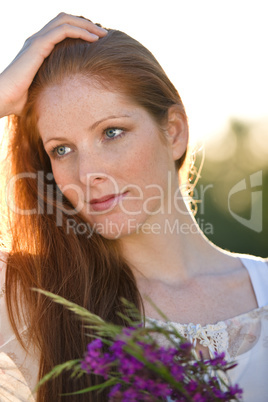 Long red hair woman with bouquet of flower