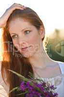 Long red hair woman with bouquet of flower