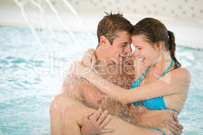 Swimming pool - young loving couple have fun