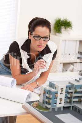 Young architect with glasses working at modern office