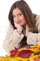 Autumn portrait of beautiful woman with leaf wearing turtleneck