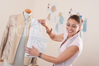 Female fashion designer working with pattern cutting