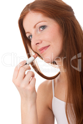 Body care series - Beautiful young woman applying lipstick