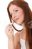 Body care series - Beautiful young woman applying lipstick