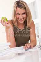 Student series - Smiling young woman sitting at white table