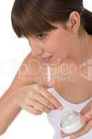 Body care - Female teenager applyi moisturizer cream