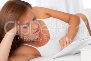 White lounge - Young woman reading white book