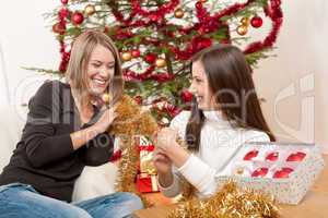Two smiling women with Christmas decoration