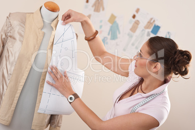 Female fashion designer working with pattern cutting