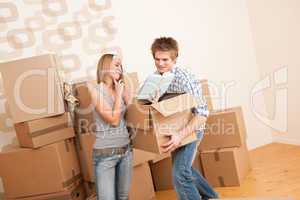 Moving house: Young couple with box