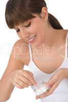 Body care - Female teenager applying moisturizer cream