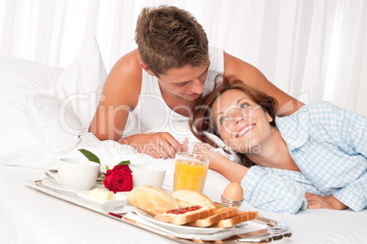 Young smiling couple having luxury breakfast